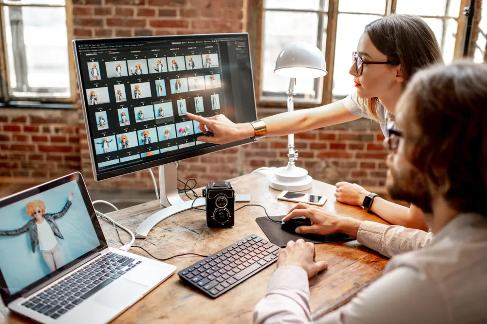 Photographer is backing up customer photos to an external hard drive and cloud storage