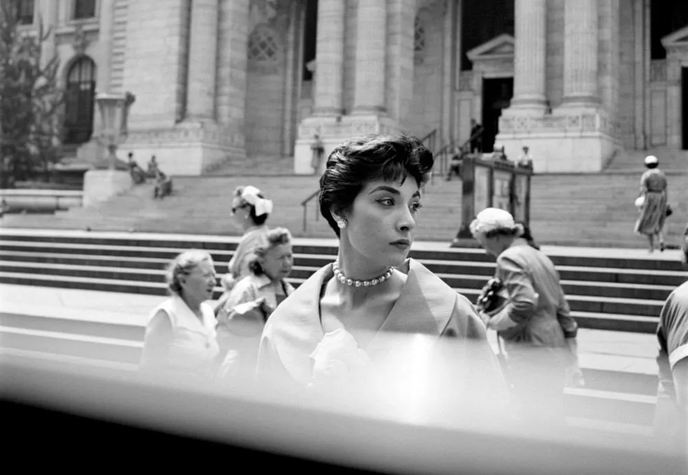 A candid portrait photo by Vivian Maier - a woman looking to the side 1702646886592