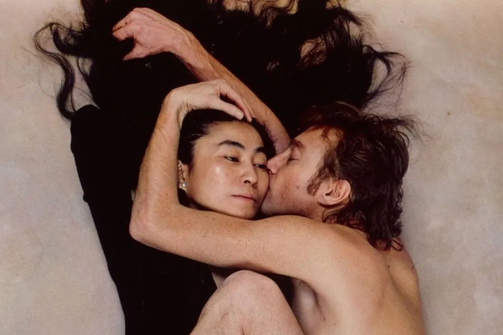 An environmental portrait photo - yoko ono and john lennon on a bed 1702646631796